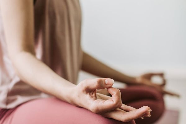 Close-up of hands in a mindful position during a yoga practice.